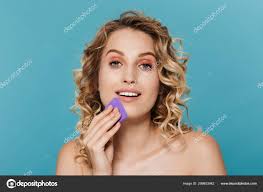 applying makeup with sponge stock photo
