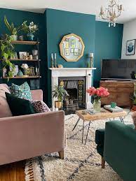 Green couch pillows, green jars, green bottles, green candles, green glasses, and green blanket are lovely selections for this living room. How To Use Dark Green In Your Living Room Melanie Jade Design