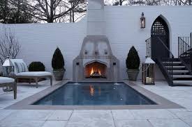in ground pool with fireplace fountains