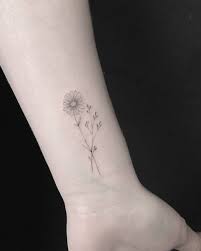 Daisy tattoos are also associated with luck, emotions, youth, happiness, and serenity but it can also represent boldness. Colorful Blowing Daisy Flower Tattoo For You Body Tattoo Art