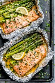 Cooking salmon in foil is a simple way to avoid washing extra dishes since the baking sheet would stay all clean. Baked Salmon In Foil Packs With Asparagus And Garlic Butter Sauce Best Salmon Recipe Eatwell101