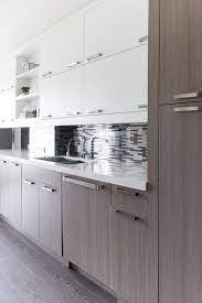 One colour for the top cabinets, an additional one for the lower cabinets, or a different colour for the cupboard doors. Oak Veneer Kitchen Cabinets With Silver And Gray Mosaic Tiles Contemporary Kitchen
