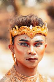 asian man in makeup with a golden crown