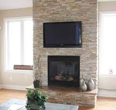 split stone fireplace with tv modern