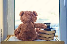 sweet teddy bear with cup of coffee at