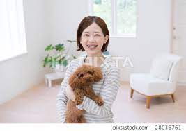 a anese woman holding a toy poodle