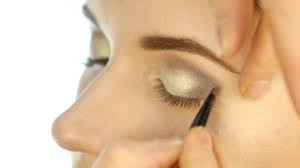 professional makeup artist applying eye