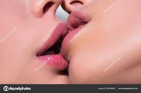 Two women kissing. Lesbian couple kiss lips. Sexy lesbian lovers foreplay.  Closeup of women mouths kissing. Stock Photo by ©Tverdohlib.com 365054986