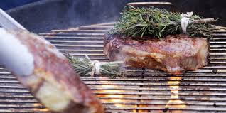 Place steak on the grill and cover. Andrew Zimmern Cooks Bone In New York Strip Steaks