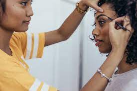 makeup artist working on eyebrows of a