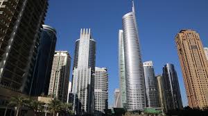 UAE, DUBAI, FEBRUARY 5, 2016: Jumeirah Lakes Towers and Almas Tower  supertall skyscraper, Dubai multi commodities centre, United Arab Emirates.  Dubai is a city and emirate in United Arab Emirates Stock Video