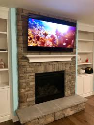 rock fireplace tv installation in