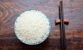How much does 100 grams of uncooked rice weigh when cooked?