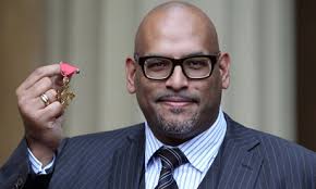 John Amaechi poses after receiving his OBE. He told &#39;Small Talk&#39; that at school he used to hide in the library. Photograph: Wpa Pool/Getty Images - john-amaechi-007
