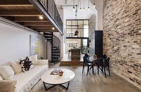 When former industrial spaces were converted into urban apartments, thea loft style adapted industrial features to achieve a cohesive look. Revamped Sydney Loft With Industrial Bones Is Headed For Auction