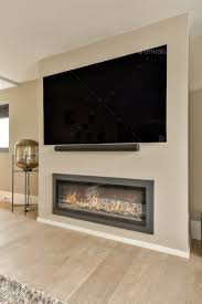 A Fireplace With A Tv Above It In A