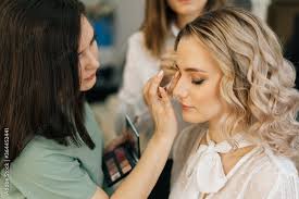 face makeup while hairdresser making