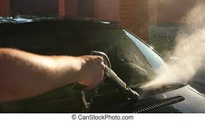 Man washing his black car near the house. Man Hosing His Car At Do It Yourself Car Wash Using High Pressure Water Spray Beautiful Scene In Front Of Sunlight Canstock