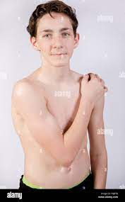 Shirtless Teenage Boy Flexing His Muscles Stock Photo - Alamy