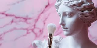 makeup brush on pink marble background