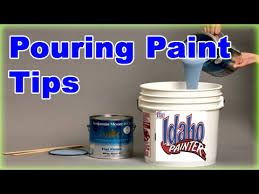 pouring paint out of a 5 gallon bucket
