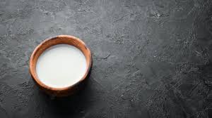Premium Photo | Milk in wooden bowl on black background top view free space  for your text