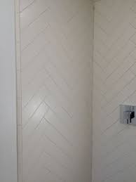 By keeping the rest of the space simple and clean, the floor pops out. Herringbone 4 X 12 Matte White Tile In The Shower White Herringbone Tile Herringbone Tile Bathroom White Herringbone Tile Bathroom