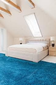 bedroom with blue carpet stock photo by