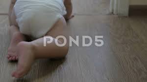 baby crawls on all fours in a diaper