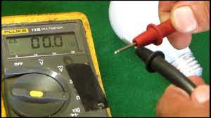 a multimeter to check a light bulb