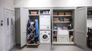 Instead of scrambling around the house checking everyone's closets for if you have space for a longer bar, make a dedicated hanging rack between cabinets or the wall. Clean Design Nine Ideas For A Home Laundry