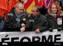 Union leaders, with CGT union Secretary General Philippe Martinez, center,  and French Democratic Confederation of Labour (CFDT) union's general  secretary Laurent Berger, left , stand behind a banner reading "Pensions  reform, working