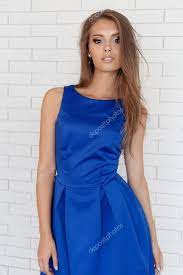 bright makeup in blue dress posing