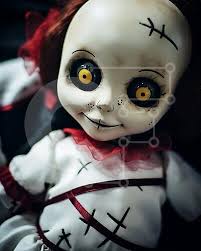 creepy doll with black eyes and red