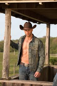 rugged shirtless cowboy on a ranch