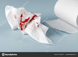 A Photo Of Used Bloody Toilet Paper And A Toilet Paper Roll