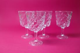Four Wine Glasses On Pink Background