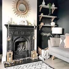 A Black Cast Iron Fireplace With Rattan