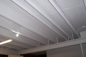 Paint the exposed rafters in the ceiling white. How To Paint A Basement Ceiling With Exposed Joists For An Industrial Look