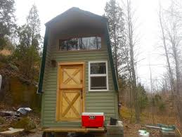 man building diy off grid tiny home for