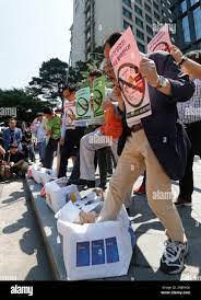 South Korean merchants trample boxes symboling Japanese products during a  rally to denounce Japanese government's decision on the trade with South  Korea in front of the Japanese embassy in Seoul, South Korea,