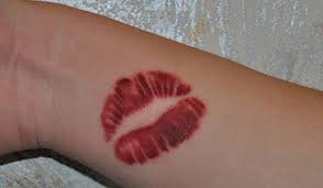 small red lips tattoo on wrist
