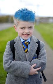 Colour image of the head and shoulders of a teenage boy with faded dyed blue hair, against an early evening sky with faint grey clouds. Rangers Mad Five Year Old Sent Home From School For Having Blue Hair Daily Record