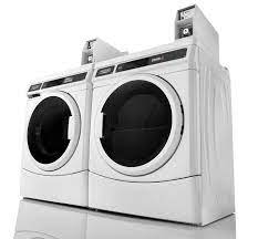 Clearing piles of laundry in front of the dryer. Commercial Laundry Products Maytag