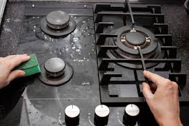 Housewife Cleans The Kitchen Gas Stove