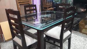 brown solid teakwood glass dining table