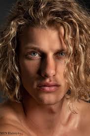 This long blonde hair men hairstyle has the fringes falling to one side. Medium Length Hairstyles For Men Are Quite Controversial While Some Call It A Blessing Others Aren T Sure Curly Hair Men Boys Long Hairstyles Blonde Hair Boy