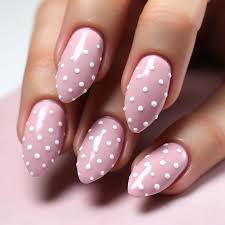 a pink and white nail with polka dots on it
