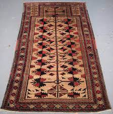 antique baluch rug with camel ground