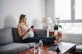 pregnant woman using smart phone while